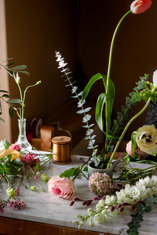 Pink Flowers and Green Foliage On A Table