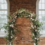 White Wedding Flower Arch With Green Foliage