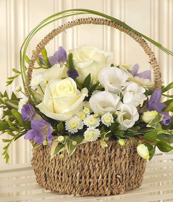 White And Purple Bouquet Displayed In A Basket