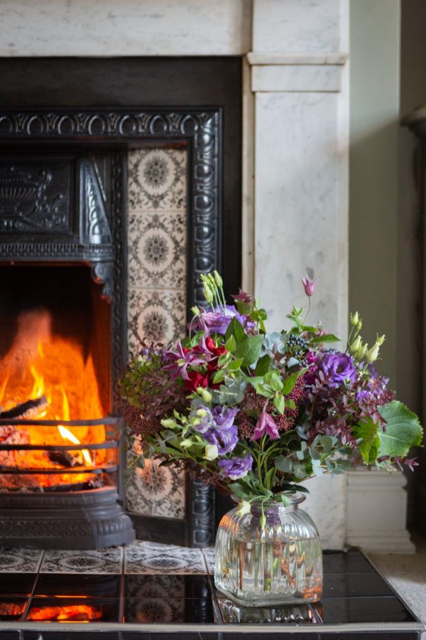 Purple And Pink Centred Bouquet By Fireplace