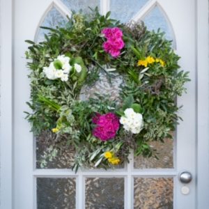 Wreath On Door With Pink White And Yellow Flowers
