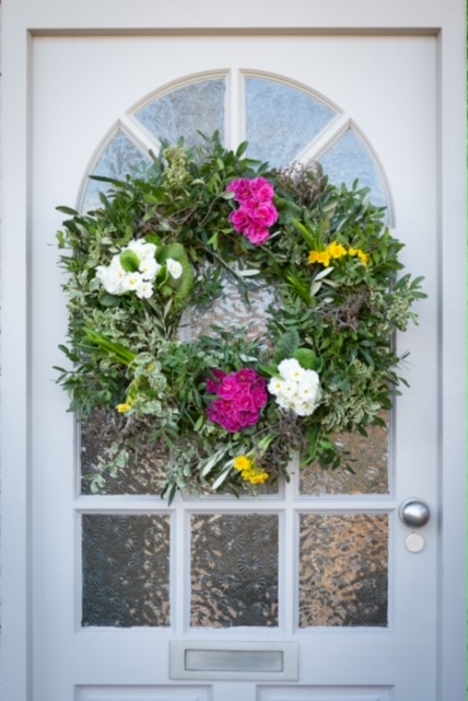 Wreath On Door With Pink White And Yellow Flowers